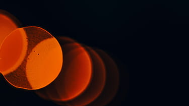 Blurry image of orange lights creating a warm, glowing ambiance used in Ashurst's Tax Controversy page.