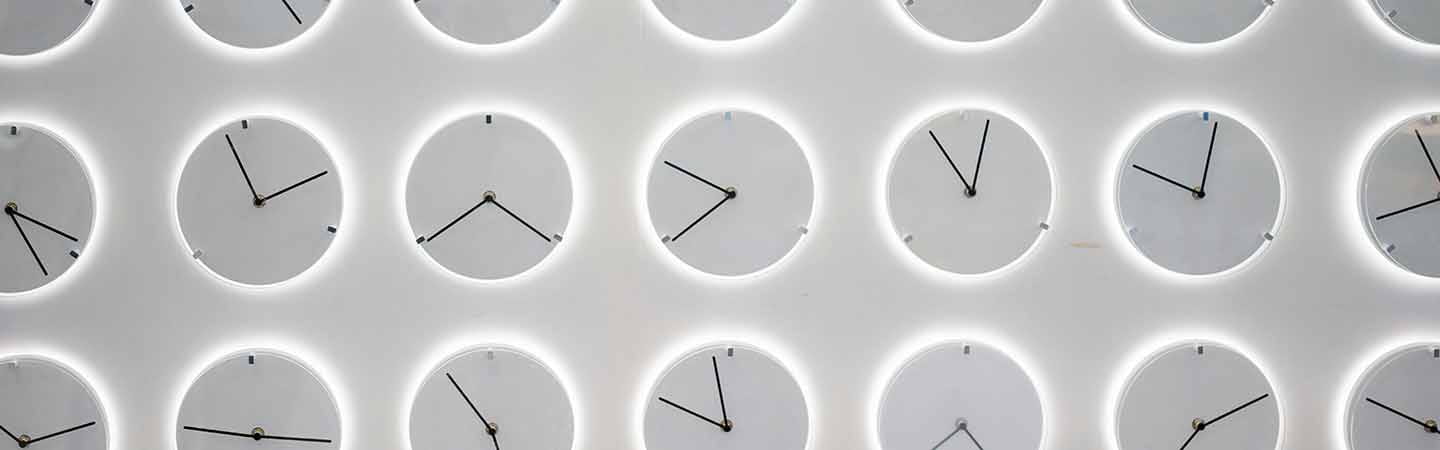 Multiple clocks set up against a grey background
