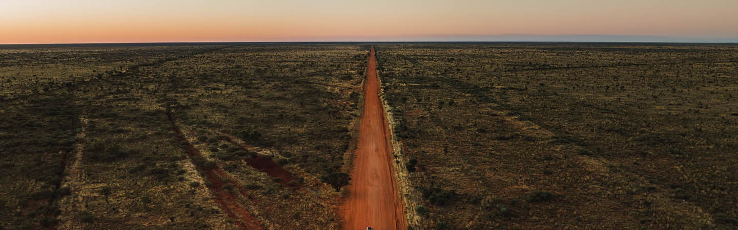 Aerial view of red dirt road through outback scrub, used in the Environment and planning year in review 2025