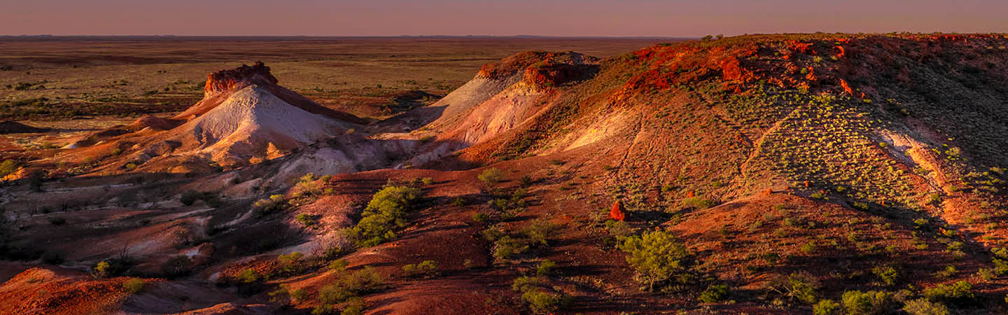 Sunset over painted desert rock formations, used in the Environment and planning year in review 2025