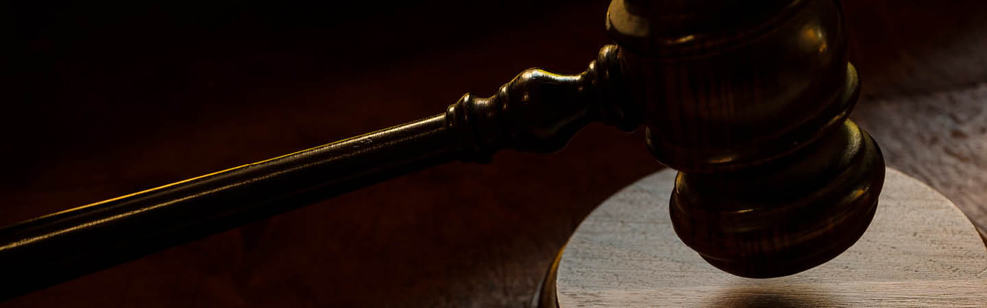 Wooden judge's gavel on dark background with dramatic lighting, used in the Environment and Planning Year in Review 2025
