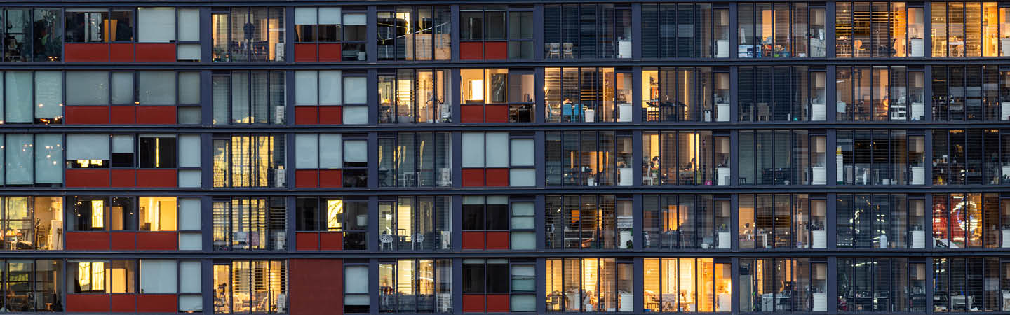 Modern high-density apartment facade at dusk, used in the Environment and planning year in review 2025