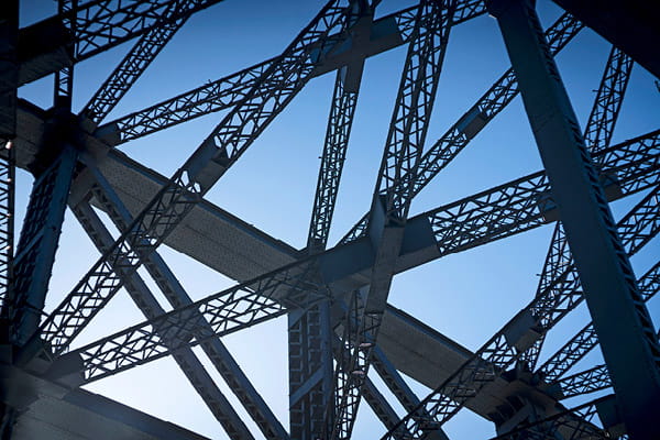 Steel columns against a blue sky image used in Ahead of the Deal Briefing series.