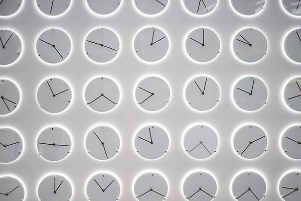 Multiple clocks set up against a grey background