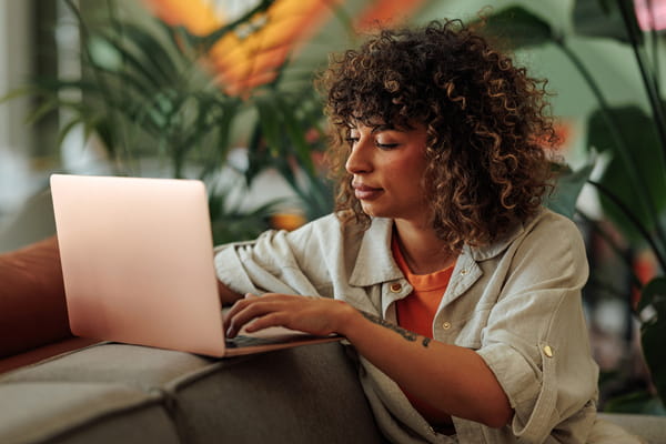 A lady operating a laptop used as an image for Ashurst Industrious Relation episode - What employers need to know about flexible work requests