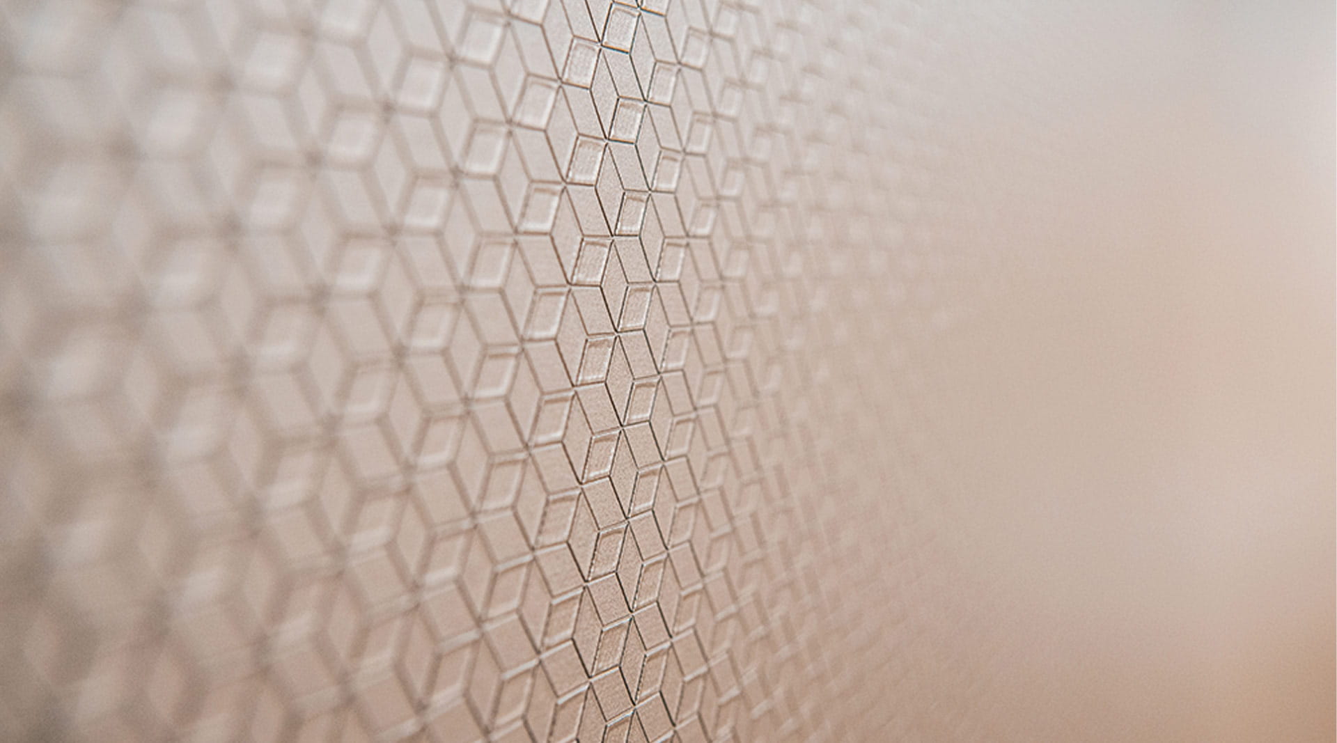 A decorative window film or glass finish featuring an abstract geometric rhombus pattern used in Ashurst Alumni news 2026.