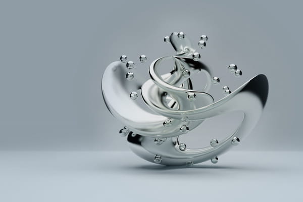 A reflective metal sphere floating in clear water, creating ripples around it.